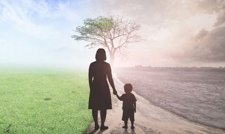 Silhouettes of a mother and young boy stand between green grass and blue sky on the left and dry, cracked earth under dark clouds on the right, facing a lone tree that is half alive and half barren