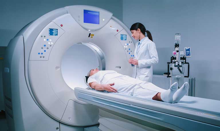 Patient receiving a CT scan in a hospital imaging suite, a diagnostic procedure used for lung cancer screening and disease detection.