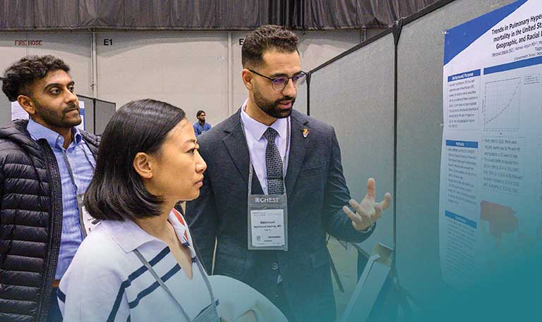 An abstract presenter talks to someone at a CHEST Annual Meeting