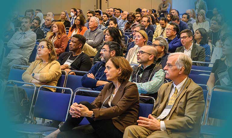 People sitting at an Annual Meeting conference