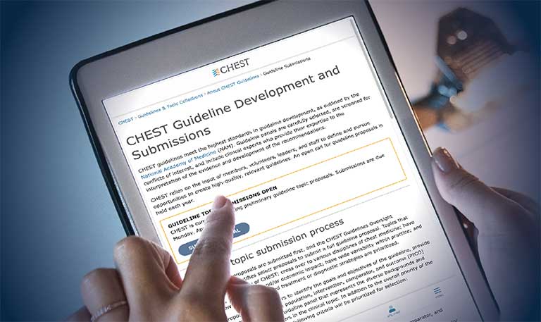 A person looking at the Guideline Submissions web page on a tablet
