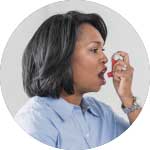 Woman using an inhaler