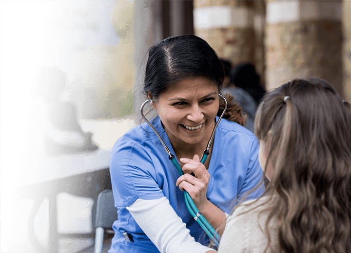 a nurse interacting with a young girl