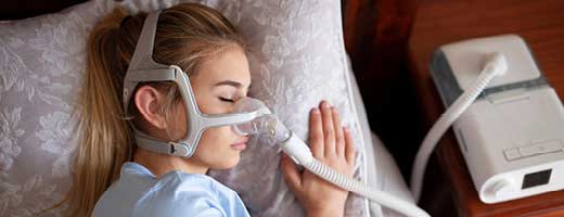 Woman sleeping with PAP device