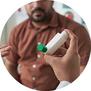 Person in a white coat holding an inhaler and talking with a man