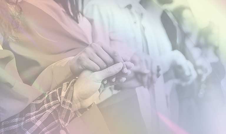 People holding hands with a rainbow overlay
