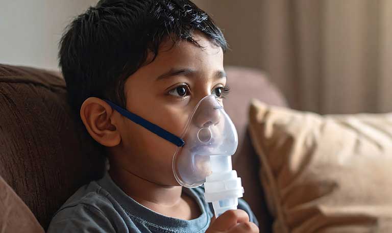 A young boy using a nebulizer