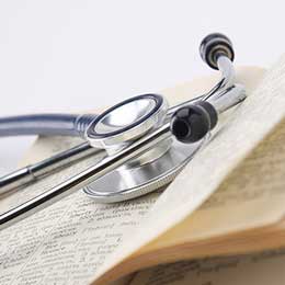 A stethoscope on top of an open book