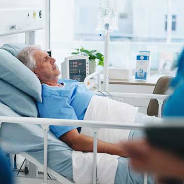A man sleeps in a hospital bed